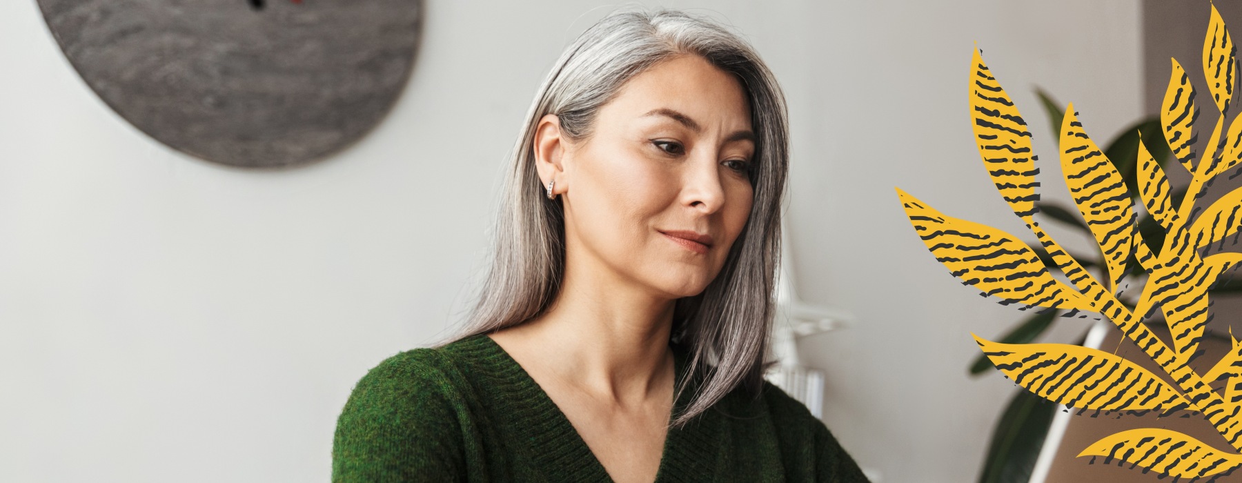 person in a green sweater sitting in front of a wall - J Veridian Upper Dublin Ft Washington luxury apts for rent Ambler
